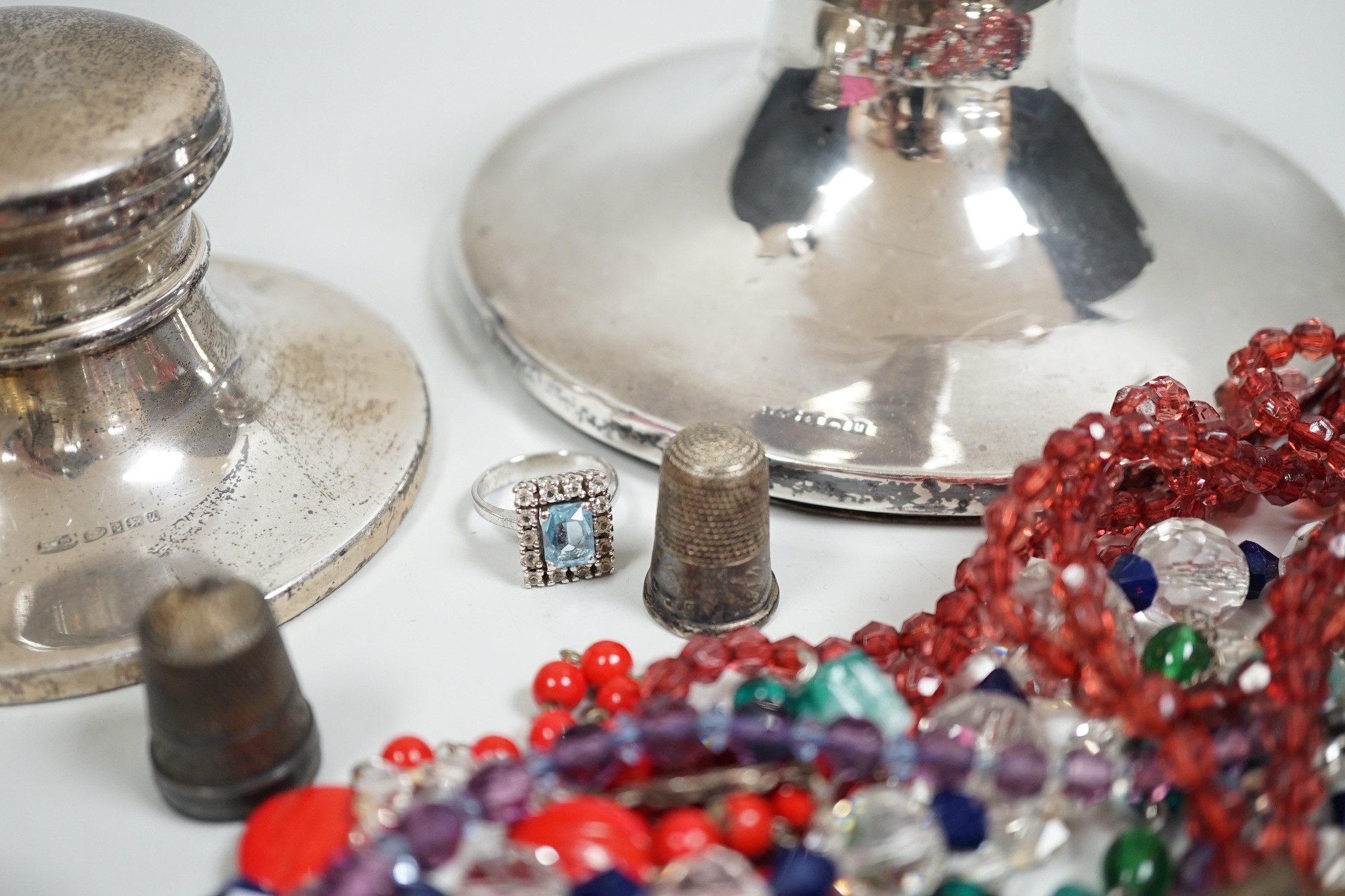 A George V silver mounted capstan inkwell, diameter 13.9cm, a later smaller inkwell and assorted jewellery including a Victorian pinchbeck scroll brooch and costume.